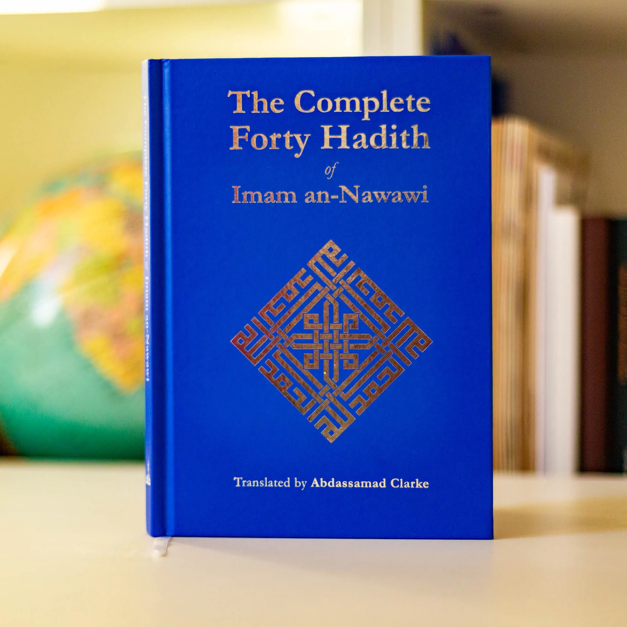 Upright book in library of The Complete Forty Hadith of Imam an-Nawawi, Abdassamad Clarke. Forty hadith collection by Ta-Ha Publishers.